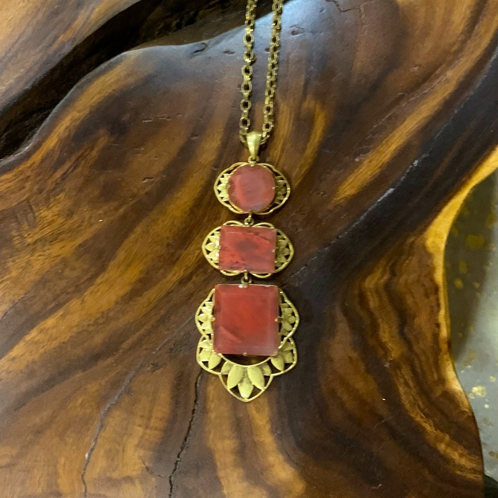 LG. brass necklace with pendant w/circular & square pink color dusted crystals.